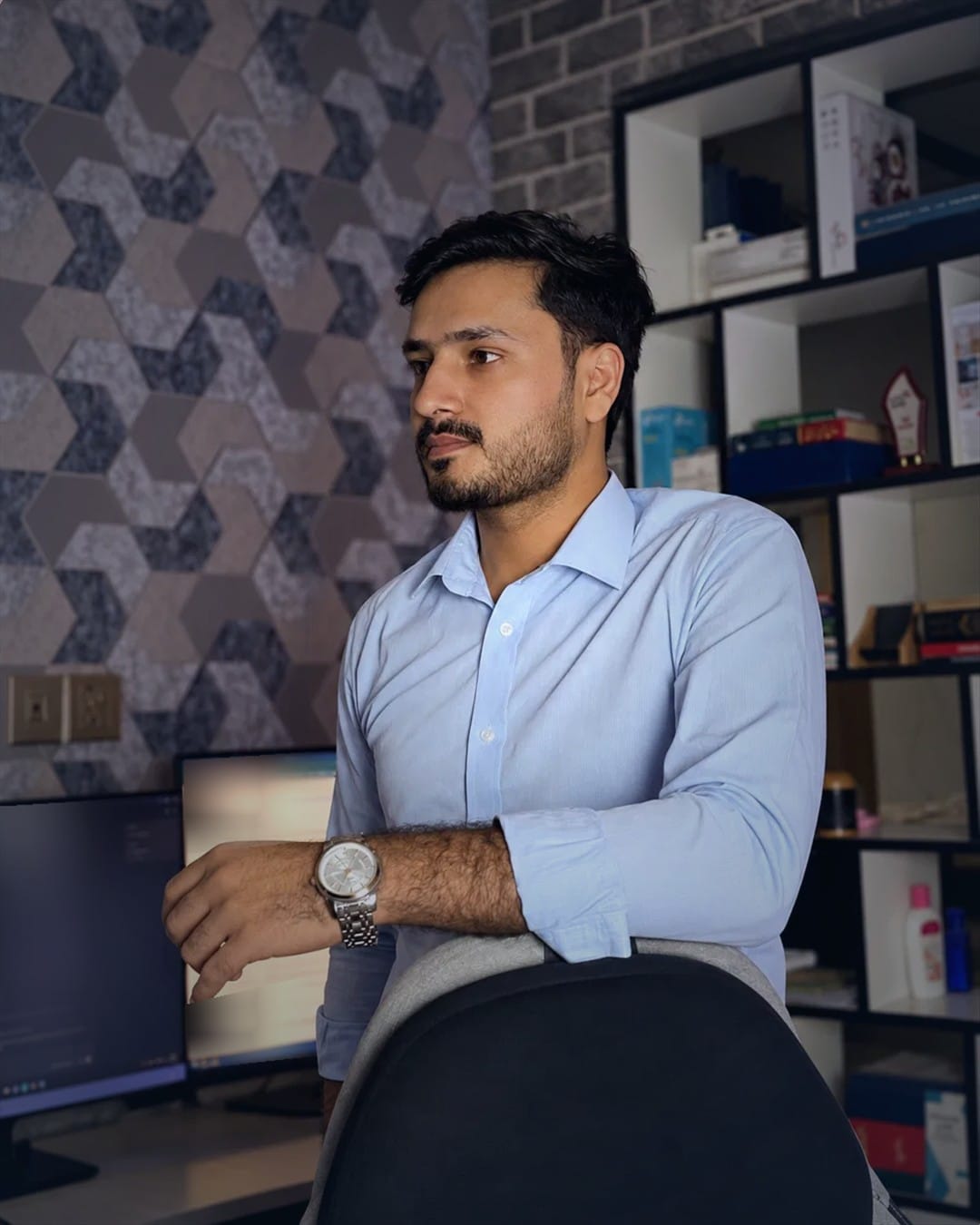 Kashif Hameed leaning on his office chair at Hawks Global