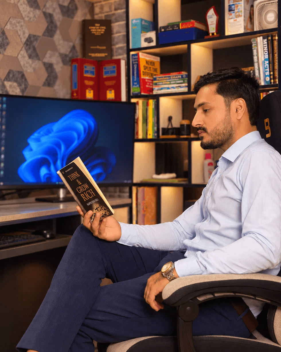 Kashif Hameed reading at his office desk